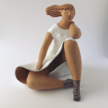 Woman Sitting in the Wind Dressed in White