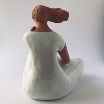 Woman Sitting in the Wind Dressed in White