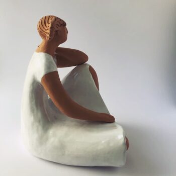 Woman Sitting in the Wind Dressed in White