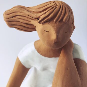 Woman Sitting in the Wind Dressed in White